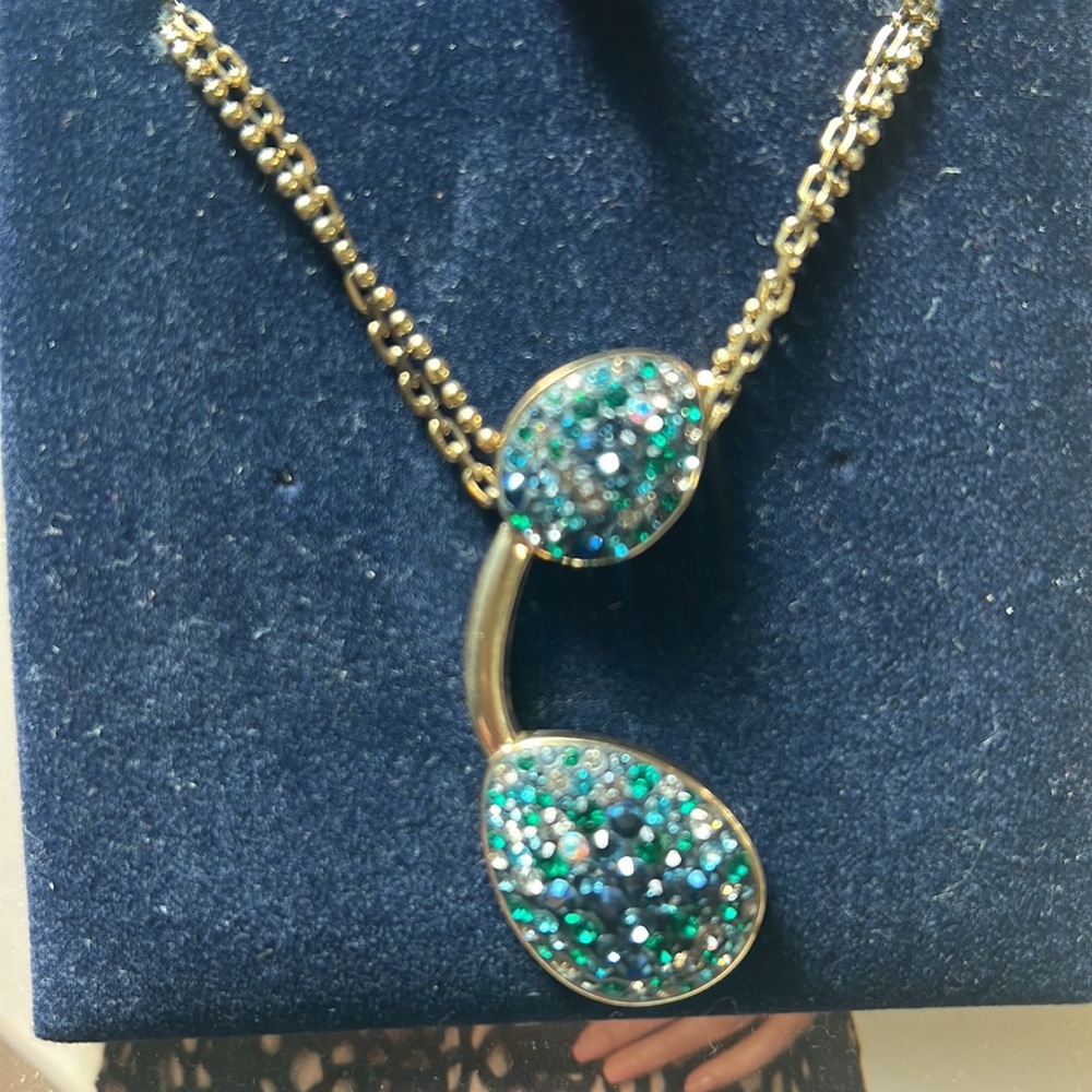 Swarovski Authentic Necklace with turquoise and blue crystals with gold chain.